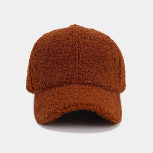 Close-up of thick dark brown teddy fleece baseball cap with soft plush texture