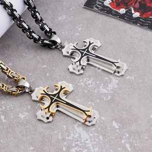 Detailed macro view of silver and gold stainless steel cross pendants on Byzantine chains