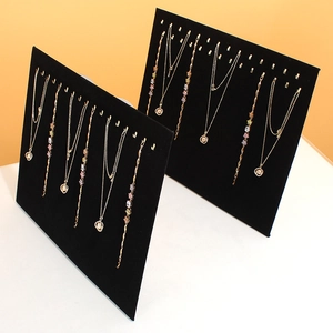 Vertical black velvet jewelry display boards with metal hooks for necklaces and bracelets