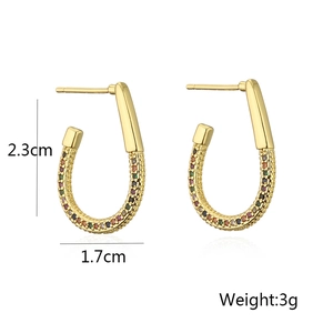 Detail shot of U-shaped gold earrings with colorful zircon stones and size dimensions