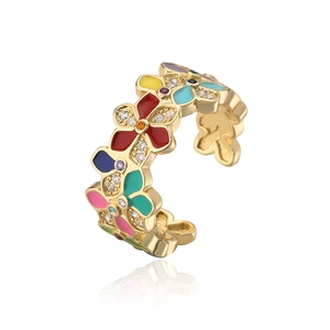 Macro detail of gold-plated open ring featuring multi-colored enamel flowers and zircons