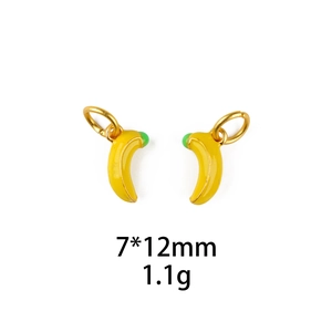 Detail of yellow banana pendant charms with green accents and golden rings for jewelry making