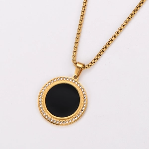 Close-up of 18k gold plated necklace with black round pendant and sparkling rhinestones