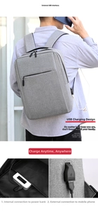 Detail of grey travel backpack showing external USB charging port and internal power cable