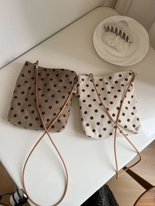 Detailed texture of polka dot corduroy crossbody bags in brown and beige tones