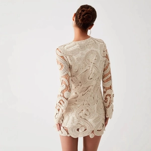 Detailed back view of crochet mini dress featuring white openwork knit patterns