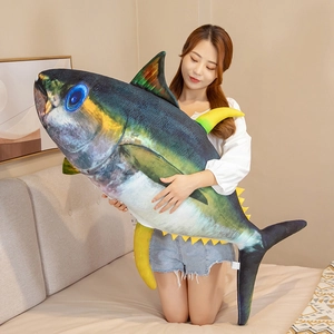Close-up of lifelike tuna plush pillow with realistic scales and yellow fin details