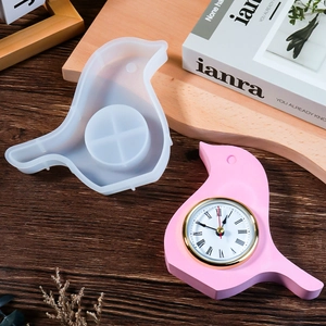 Bird-shaped silicone resin mold with finished pink clock and Roman numeral dial detail