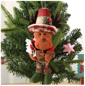Detailed view of a plush Christmas reindeer ornament with a plaid hat hanging on a tree
