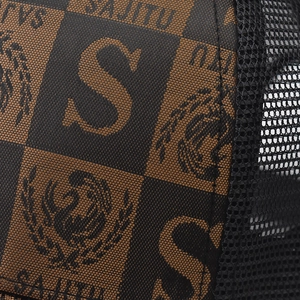Macro view of plaid checkerboard fabric and breathable mesh on a baseball cap