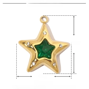 Macro detail of star pendant dimensions 17mm by 15mm with green stone and gold plating