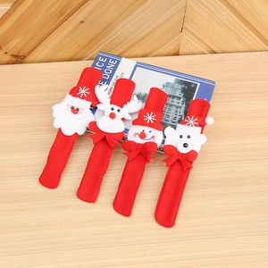 Detail view of four Christmas snap bracelets featuring Santa, polar bear, snowman and reindeer