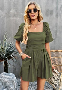 Detail of olive green short sleeve romper showing square neck and side pocket design