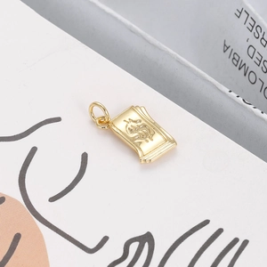 Macro view of gold plated money stack pendant with dollar sign and fine textures