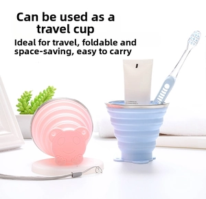 Detail of pink and blue collapsible silicone travel cups with bear lids and metal rims