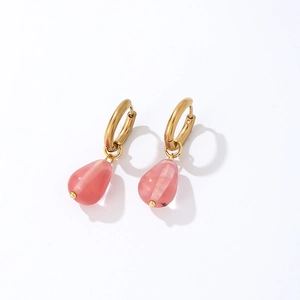 Detail of golden hoop earrings with translucent pink teardrop natural stone pendants