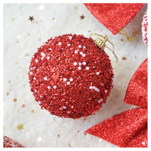 Macro shot of red Christmas ball with shiny sequins, white pearls and gold metal hook