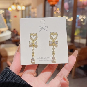 Close-up of heart bow drop earrings with white zircons and S925 silver needle