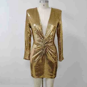 Détail d'une robe dorée à paillettes avec col en V profond et taille drapée ajustée