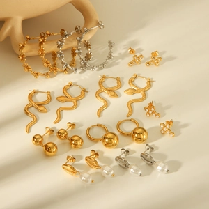 Assorted gold and silver stainless steel earrings featuring floral and pearl designs