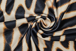 Detailed view of silky animal print fabric showing smooth texture and giraffe pattern