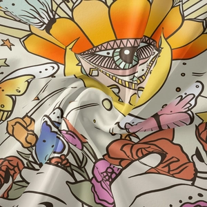 Detailed close-up of bohemian tapestry fabric with floral butterfly and eye patterns