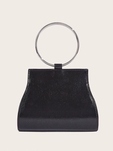 Close-up of black patent leather evening clutch featuring a silver ring handle