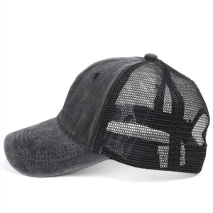 Detail view of washed denim trucker hat with vintage grey fabric and black mesh panel