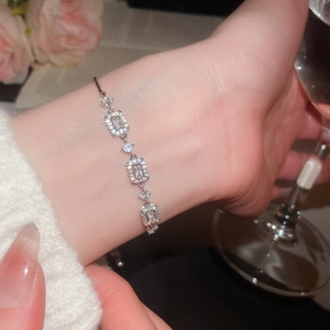 Close-up of elegant silver bracelet with sparkling zircon stones worn by a model