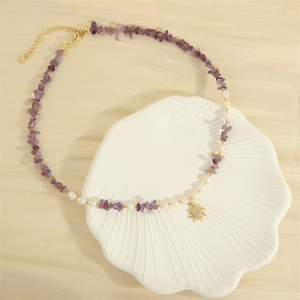 Bohemian freshwater pearl necklace with purple gravel stones and golden sun pendant