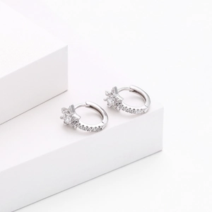 Detail of S925 silver hoop earrings with sparkling diamond-set star charm design