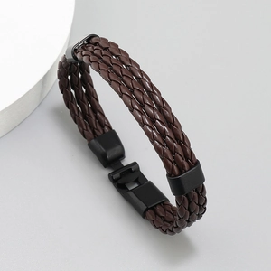 Detailed view of brown braided leather layers with black metal clasp for men