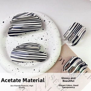Glossy acetic acid hair clips featuring minimalist black and white zebra stripe patterns