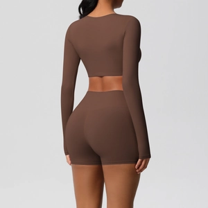 Detail of the high-waisted lifting shorts and long sleeve top from the coffee yoga set