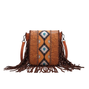 Detailed view of bohemian crossbody bag with fringe, ethnic weaving and floral embossing