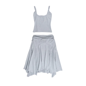 Detailed flat lay of a grey two-piece set featuring a crop top and ruffled asymmetric skirt