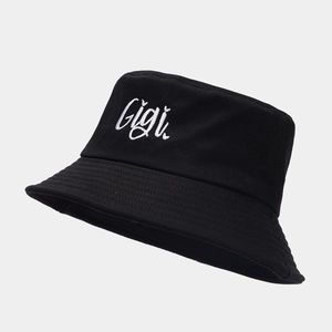 Close-up of fine white Gigi embroidery and reinforced stitching on a black bucket hat
