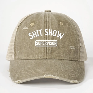 Detail of distressed khaki trucker hat showing breathable mesh and Shit Show Supervisor text