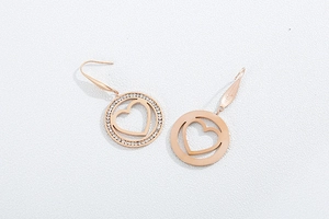 Detailed view of rose gold hollow heart drop earrings with sparkling rhinestone pavé setting