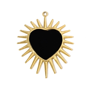 Detailed view of heart-shaped gold pendant with black inlay and sunburst star detail
