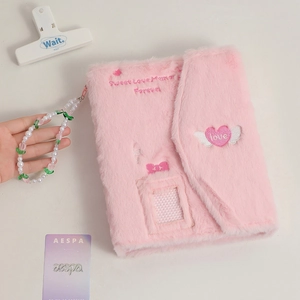 Detail of pink plush A5 binder featuring heart embroidery and beaded charm accessory