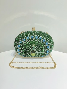 Detail of peacock evening bag with green and blue crystals and golden chain strap