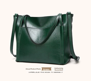 Detailed view of the dark green oil wax leather tote bag featuring elegant V-shaped stitching