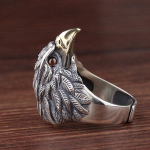 Macro shot of vintage eagle ring with gold beak detail and brown gemstone eyes