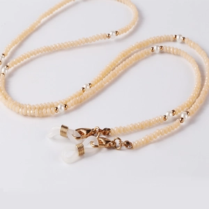 Detailed macro view of champagne crystal beads and white pearls for glasses chains