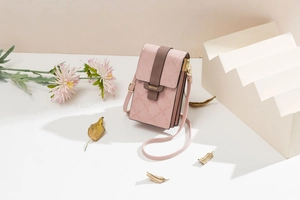 Close-up of pink PU leather mini mobile phone bag with flap and metal logo buckle