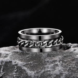 Macro view of rotating Cuban chain ring with vintage silver finish on dark stone