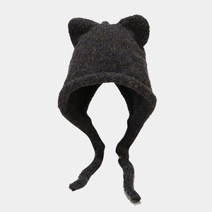 Close-up of cat ear knit beanie featuring thick mixed blue-grey yarn and long braided ties