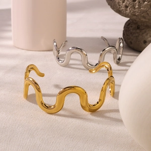Minimalist polished stainless steel wavy open bangle in gold and silver finishes