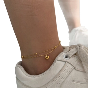 Double-layer gold stainless steel anklet with beads and heart pendant on model